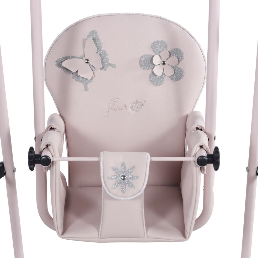 Columpio fleur rosa, con asiento decorado con una mariposa y flores en tonos plateados.
